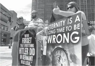  ?? Associated Press ?? ■ Abortion opponents with the group Operation Save America gather July 19, 2017, during a rally in downtown Louisville, Ky. On July 21, 2017, a federal judge establishe­d a buffer zone outside the EMW Women’s Surgical Center in Louisville to keep...