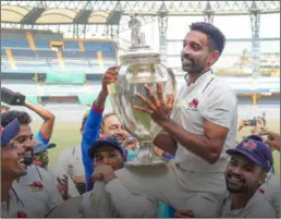  ?? ?? Mumbai captain Ajinkya Rahane and other players celebrate with the coveted Ranji Trophy at the Wankhede Stadium in Mumbai on Thursday.