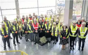  ??  ?? >
Contractor Willmott Dixon joins staff from Birmingham City University in a topping out ceremony at the new £31 million Curzon B extension.