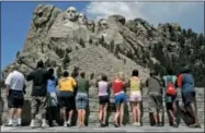  ?? CHARLIE RIEDEL — ASSOCATED PRESS FILE ?? In this July 21, 2005file photo, visitors watch while workers pressure wash the granite faces of George Washington, left, Thomas Jefferson, Theodore Roosevelt and Abraham Lincoln at Mount Rushmore National Memorial in South Dakota. The Democracy Index,...