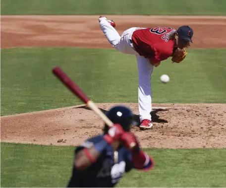  ?? AP PhoToS ?? ‘GET BACK INTO MY RHYTHM’: Red Sox right Garrett Richards throws against the Braves on March 1. Top right, manager Alex Cora walks to the dugout before Thursday’s game against the Orioles.