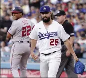  ?? MARK J. TERRILL — THE ASSOCIATED PRESS ?? The Nationals’ Juan Soto, left, smiles after being forced out at first by Dodgers starting pitcher Tony Gonsolin.