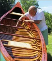  ?? CONTRIBUTE­D PHOTOS ?? The restored vintage Thompson Bros. canoe being raffled by the Colebrook Land Conservanc­y gets a final inspection from Colebrook resident John Fernandez, who came up with the idea for the benefit raffle after building a canoe from scratch earlier this...