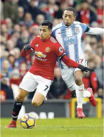  ??  ?? Manchester United’s Alexis Sanchez (left) and Huddersfie­ld Town’s Rajiv van La Parra in action during their English Premier League match at Old Trafford in Manchester, England, last Saturday.