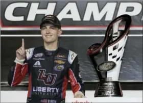  ?? TERRY RENNA - AP ?? William Byron poses with his trophy in Victory Lane after winning the NASCAR Xfinity Series auto racing championsh­ip at Homestead-Miami Speedway in Homestead, Fla., Saturday.