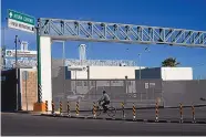  ?? FERNANDO LLANO/ASSOCIATED PRESS ?? A man rides his bike past the closed main entrance to the internatio­nal border bridge which connects the cities of Del Rio, Texas, and Ciudad Acuña, Mexico, in September.