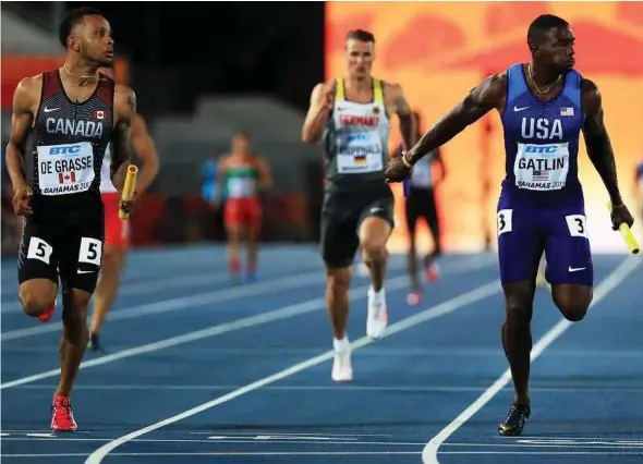  ?? AFP PIC ?? Andre De Grasse (left) and Justin Gatlin (right) finished second and third in last year’s Olympics 100m final.