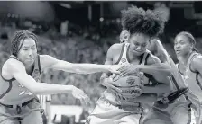  ?? CARMEN MANDATO/GETTY ?? UConn’s Christyn Williams battles Arizona’s Bendu Yeaney during the third quarter in a Final Four game Friday at the Alamodome in San Antonio. Williams had 20 points in UConn’s 69-59 loss to the Wildcats.