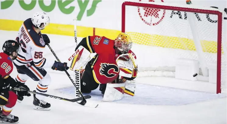  ?? JEFF MCINTOSH /THE CANADIAN PRESS ?? Edmonton Oilers forward Kailer Yamamoto, seen scoring the first of his two goals on the night past Calgary Flames goalie David Rittich, was the best player in white during Monday’s exhibition game in Calgary, where the Oiler scored a 7-4 victory over a Flames team missing essentiall­y every regular on its roster.