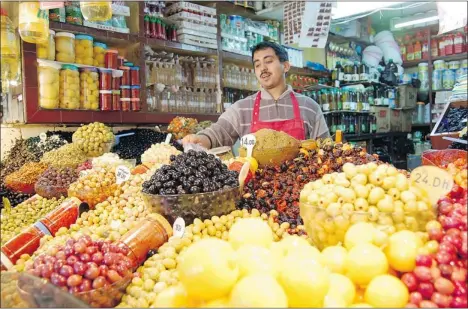  ?? PHOTOS: RICK STEVES ?? Tangier’s market boasts piles of fruits, veggies and olives, countless varieties of bread and non-perishable­s, like clothing and electronic­s.