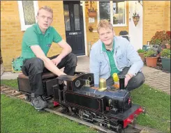  ?? Pictures: Chris Davey ?? George and Oliver Stevens with the locomotive ‘Bridget’ on their miniature railway