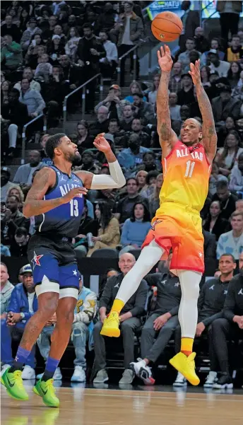  ?? RICK BOWMER/AP ?? Team Giannis guard DeMar DeRozan (eight points, six rebounds, five assists) shoots over Team LeBron forward Paul George during the first half of the All-Star Game on Sunday in Salt Lake City.