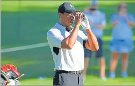  ?? USA TODAY SPORTS ?? Tiger Woods checks the yardage to the 10th green at Southern Hills Country Club.