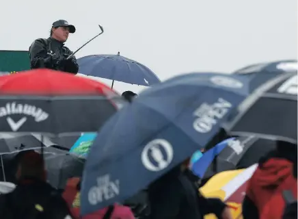  ??  ?? SWINGING IN THE RAIN: Phil Mickelson continued to dominate in trying conditions at Royal Troon yesterday.