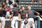  ?? ROSS CAMERON / ASSOCIATED PRESS ?? Stanford’s Kody Huff (25) is congratula­ted by teammates Brett Barrera, Braden Montgomery (6) and Adam Crampton (10) after hitting a grand slam against Connecticu­t on Monday.