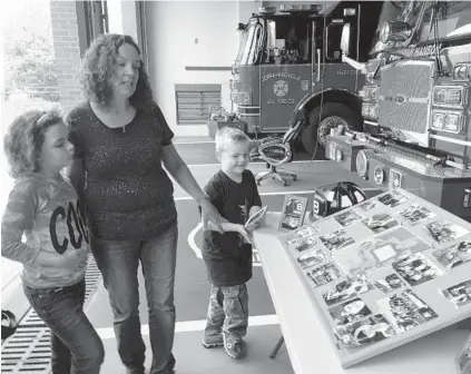  ?? DAVID ANDERSON/BALTIMORE SUN MEDIA GROUP PHOTOS ?? Karen Nicholson of Edgewood shows the many things members of the Joppa-Magnolia Volunteer Fire Company did to help her son, Nathaniel, right, when he was battling cancer.