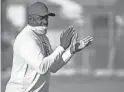  ??  ?? New football head coach Byron Evans encourages his team during a July 28 workout at South Mountain High School.