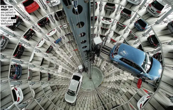  ?? PILE ’EM
HIGH Cars are parked in the delivery tower at VW’s plant in Wolfsburg ??