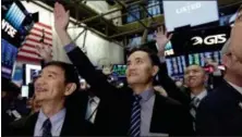  ?? RICHARD DREW — THE ASSOCIATED PRESS ?? Jianpu Technology’s co-founder & CEO Daqing Ye, center, waves to a gallery in the New York Stock Exchange as he waits for his company’s IPO to begin trading, Thursday.