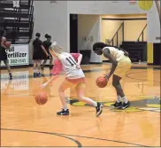  ??  ?? Juniors Megan Little and Keyarah Berry participat­e in a dribbling drill during a recent practice session for the Lady Jackets ahead of the start of the 2019-2020 basketball season.