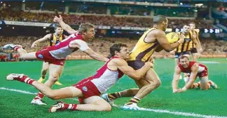  ??  ?? Footy or Australian Rules Football is a very physical contact sport.