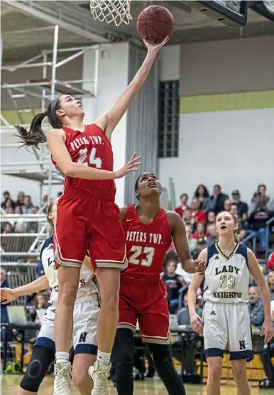  ?? Alexandra Wimley/Post-Gazette ?? Peters Township’s Mackenzie Lehman drives to the basket for a layup in the PIAA quarterfin­als against Norwin Friday at Keystone Oaks High School in Dormont.