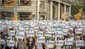  ??  ?? Taking a stand: Protesters waving signs during a demonstrat­ion against the Spanish government and putting separatist leaders in jail. — Bloomberg