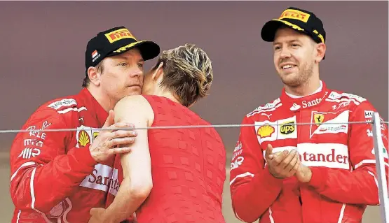  ??  ?? Selbst der Kuss von Fürstin Charlène von Monaco konnte Kimi Räikkönen im Beisein von Sieger Sebastian Vettel nicht aufheitern.