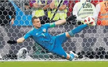  ?? /Reuters ?? On the spot: Russia’s captain, Igor Akinfeev, saves Iago Aspas’s penalty with his boot to knock Spain out of the World Cup. Earlier the goalkeeper saved Koke’s penalty.