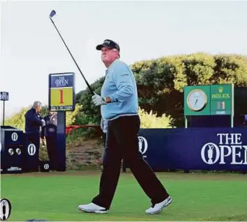  ?? Reuters ?? Colin Montgomeri­e walks off the first tee during the first round of the British Open. The Scotsman, a member at Royal Troon, was given the honour of hitting the first shot.
