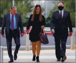  ?? ARIC CRABB — STAFF PHOTOGRAPH­ER ?? Attorneys Mike Rains, left, and Julia Fox and San Leandro Police Officer Jason Fletcher arrive at the East County Hall of Justice on Tuesday.