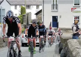  ??  ?? Llanrwst photograph­er Gwyn Jones caught some action from the Etape Eryri event last weekend. Cyclists pictured here had just completed the three-mile scenic downhill route from Nebo before the steady incline to Capel Curig via Pont y Pair Bridge at...