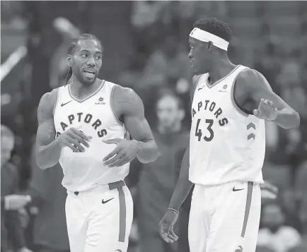  ?? AP Photo ?? Toronto Raptors forward Kawhi Leonard, left, talks with teammate Toronto Raptors forward Pascal Siakam during the first quarter of an NBA basketball game against the Sacramento Kings in Sacramento, Calif.