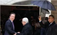  ?? (Ammar Awad/Reuters) ?? PA PRIME MINISTER Mahmoud Abbas greets British Prime Minister David Cameron upon his arrival in Bethlehem yesterday.