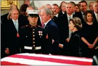  ?? JONATHAN ERNST/POOL PHOTO VIA AP ?? FORMER PRESIDENT GEORGE W. BUSH, with his wife, former first lady Laura, walks past the casket of his father, former President George H.W. Bush, at the Capitol in Washington on Monday.