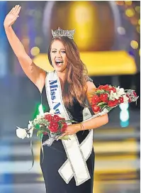  ?? — Gambar Reuters ?? TERUJA: Mund melambaika­n tangannya kepada hadirin selepas dinobatkan sebagai Miss America ke-97 di Atlantic City, New Jersey kelmarin.