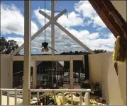  ?? CLAIRE OSBORN / AMERICAN-STATESMAN ?? Officials say a tornado ripped the roof off this house on Venture Boulevard in Point Venture along Lake Travis.