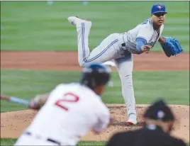 ?? The Associated Press ?? Toronto Blue Jays starting pitcher Marcus Stroman gets Boston Red Sox’s Xander Bogaerts to chase a pitch on a strikeout during first-inning AL action in Boston on Monday. The Blue Jays held on to win 4-3.
