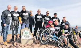  ??  ?? Specsavers directors, team members and Cerebra staff with Imogen at the summit of Pen y Fan.