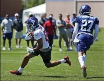  ?? THE ASSOCIATED PRESS ?? Giants’ Evan Engram, left, evades Darian Thompson during training camp Sunday in East Rutherford.