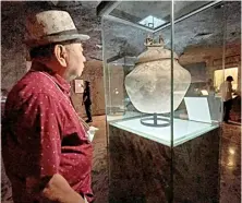  ?? PHOTOGRAPH COURTESY OF MERVIN CONCEPCION VERGARA ?? ALMARIO looking at the late Neolithic period Manunggul Jar, a National Cultural Treasure.