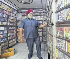  ?? AMAL KS/HT PHOTO ?? (Right) Jagdish Seth at his DVD shop near Nirman Vihar in east Delhi. Seth has 50,000 DVDS in his shop and believes CDS and DVDS will return one day. (Above) Gurdeep Singh says digital music sounds jarring after a few hours.