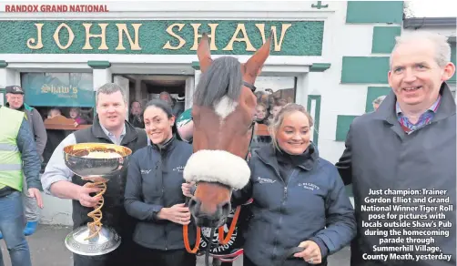  ??  ?? Just champion: Trainer Gordon Elliot and Grand National Winner Tiger Roll
pose for pictures with locals outside Shaw’s Pub during the homecoming
parade through Summerhill Village, County Meath, yesterday