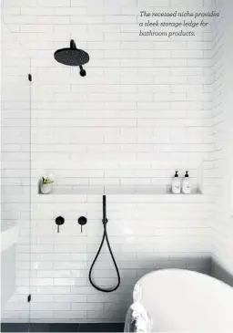 ??  ?? The recessed niche provides a sleek storage ledge for bathroom products.