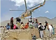  ?? ?? A Taliban helicopter takes off after bringing aid to the site of an earthquake in Gayan, Afghanista­n