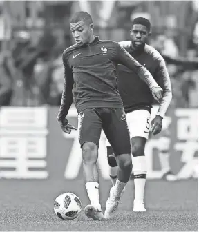  ??  ?? France's Kylian Mbappe warms up ahead of the quarterfin­al match between Uruguay and France at the 2018 soccer World Cup in the Nizhny Novgorod Stadium, in Nizhny Novgorod, Russia on Friday. MARTIN MEISSNER/AP