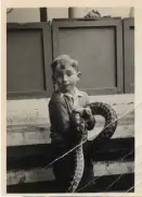  ??  ?? Hinton, age 8, at the Bristol Zoo, holding a python. For a time, the Hinton family kept vipers in a pit in their garage