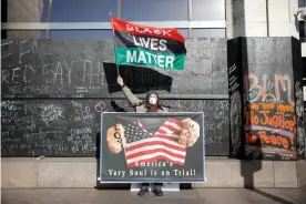  ?? Photograph: Nicholas Pfosi/Reuters ?? Activist Stephen Parlato stands outside the Hennepin County Government Center where the Derek Chauvin trial is taking place.