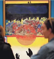  ?? OKLAHOMAN DOUG HOKE/THE ?? Visitors look at David C. Driskell’s 1972 acrylic on canvas painting “Swing Low, Sweet Chariot” during a media tour of the special exhibition “Art and Activism at Tougaloo College.”