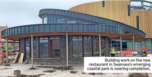  ?? ?? Building work on the new restaurant in Swansea’s emerging coastal park is nearing completion.